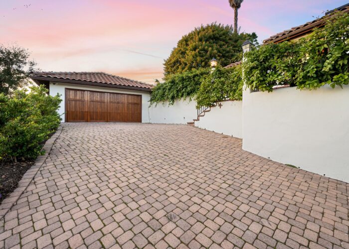 a-driveway-with-brick-pavers-and-a-garage-in-the-2024-02-12-16-49-28-utc-min a-driveway-with-brick-pavers-and-a-garage-in-the-2024-02-12-16-49-28-utc-min